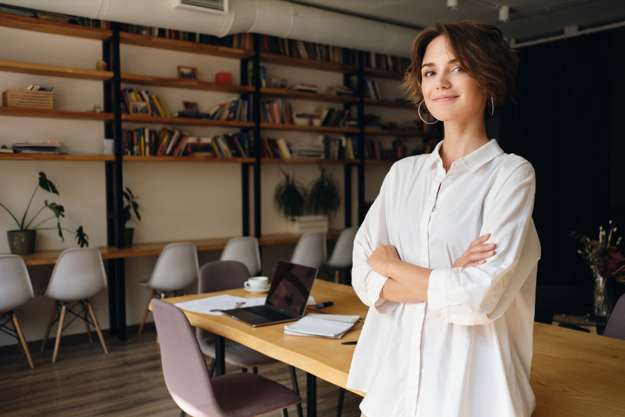 Young attractive woman in white shirt dreamily looking in camera